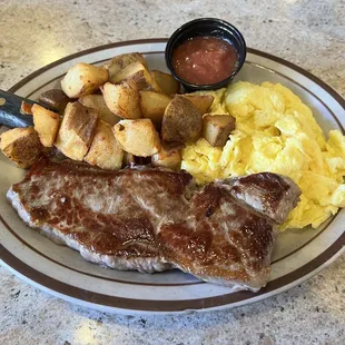 8 oz New York Steak with scrambled eggs and home fries