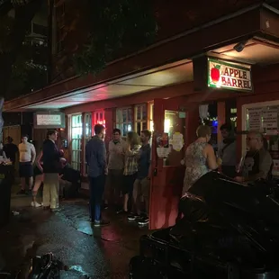 people standing outside at night