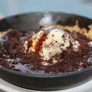 The Skillet Cookie is made with a salted chocolate chip cookie, your choice of ice cream (we chose cookie dough), &amp; chocolate sauce