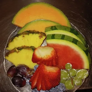 a plate of fruit and grapes