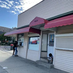 a woman standing outside of a store