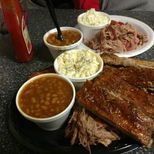 The three meat combo, ribs, pulled pork and brisket with baked beans and potato salad.