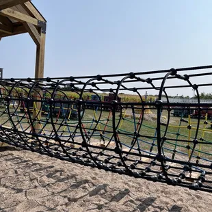 a playground with a rope fence