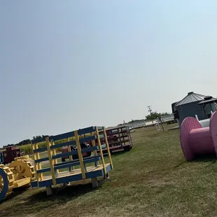 a tractor pulling a trailer with a pink hose attached to it