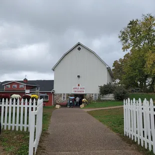 a white barn with a white picketer