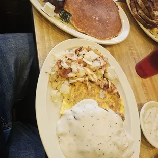 Country fried steak and eggs with a side of pancakes