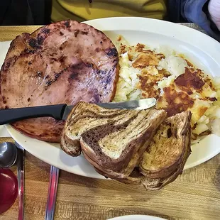 Ham steak breakfast with eggs,hashbrowns and rye toast