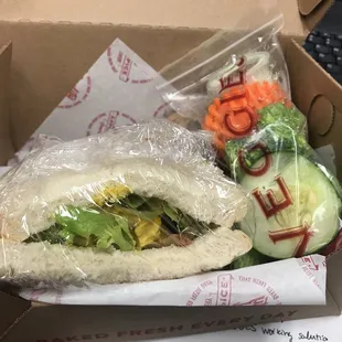 Cute to go box! Curry chicken Sandwich with a side of veggies and sauce