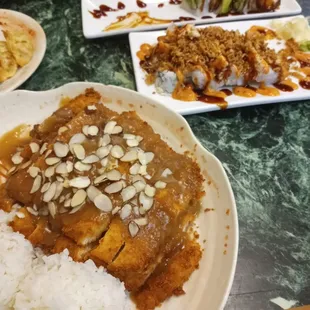 a plate of rice and a plate of sushi