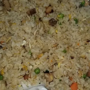 Deluxe fried rice  Made with rice, chicken, shrimp, pork, carrots, peas, and onion.