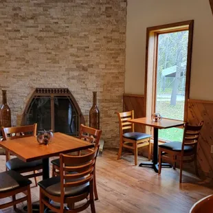 Tables by the fireplace, and nice outdoor fall views.