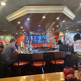 customers sitting at the bar