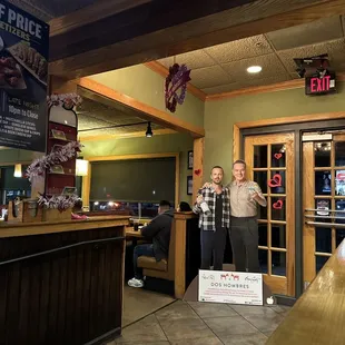 two men standing in front of the counter
