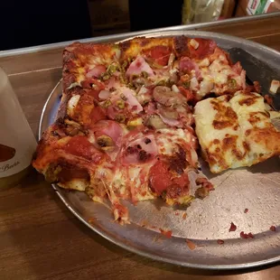a half eaten pizza on a pan