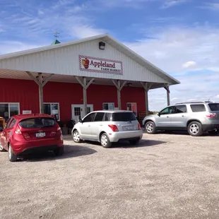 several vehicles parked in front of the building