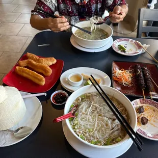 a woman eating a bowl of noodles