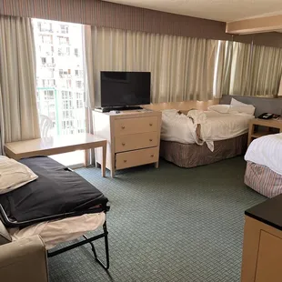 Deluxe room with pull out double bed, single bed, and a queen bed