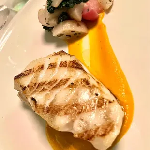 Grilled sea bass with braised radishes, turnips, kale, and curried carrot butter