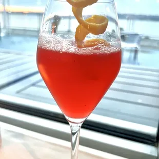 French Cannons cocktail made with strawberry-infused gin, limoncello, simple syrup, rosé bubbles, lemon juice, &amp; soda