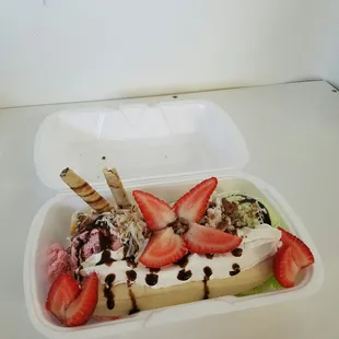 a banana split with strawberries and chocolate chips