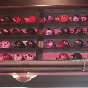 NFL helmets on display. One team missing. Come by and try to find out which one it is.