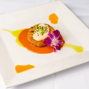 a plate of food on a white tablecloth