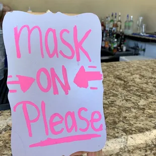 a sign that reads mask on please