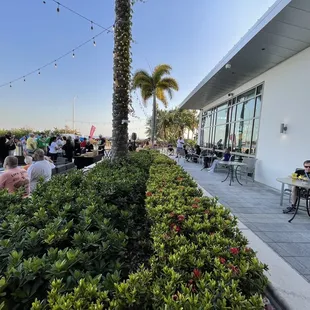 a group of people sitting at tables outside