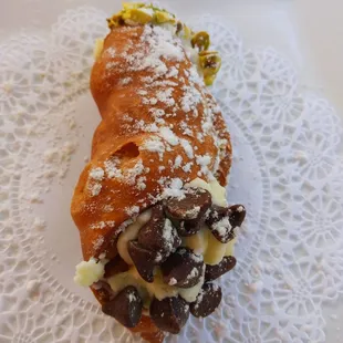 Fresh cannoli.  Delicious. Half chocolate chips and half pistachios.