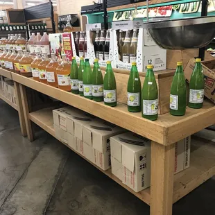 a variety of bottles of water on a table in a grocery store