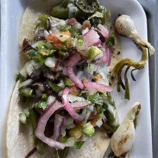 2 tacos asada, very delicious  with a side of grilled onions