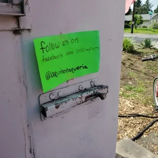 a sign on a wall with donuts