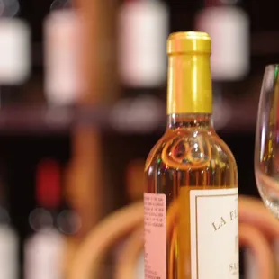 Our favorite dessert wine at Aquitaine, with the retail shelves behind