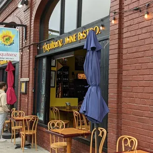 outside of a restaurant with tables and chairs