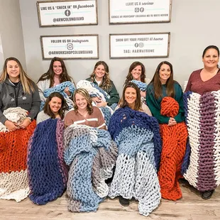Team Building Event making chunky knit blankets.