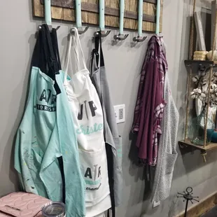 The personalized white aprons are for the frequent fliers, but they keep plenty of teal aprons for everyone else.