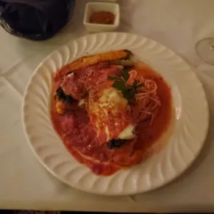 Chicken with pasta topped with spinach and cheese