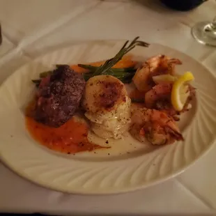 Trio - filet mignon, stuffed crab and prawns with potatoes au gratin