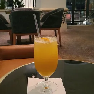 a glass of orange juice on a table