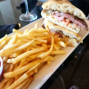 a plate of french fries and a sandwich