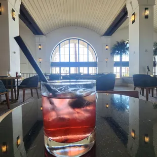 a drink in a glass on a table