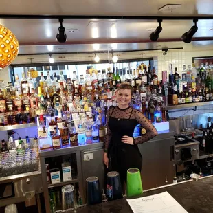 a woman behind a bar counter