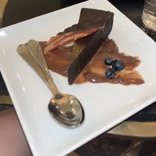 a piece of cake on a plate with a spoon