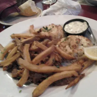 Crab cakes with tartar sauce and french fries