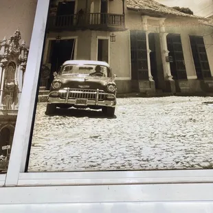 an old car parked in front of a building