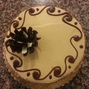 a white cake with chocolate decorations