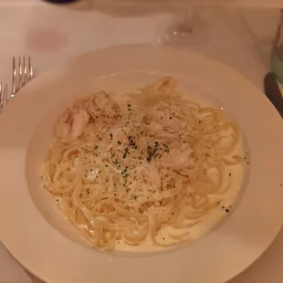 a plate of pasta and a glass of wine