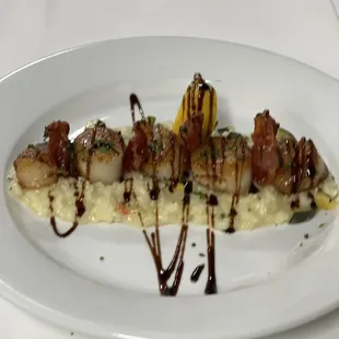 Scallops over primavera risoto finish with crispy prosciutto and glazed balsamic