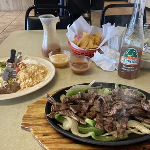 Steak fajitas, comes with rice and beans. Washed down with a tanmarid Jarrito