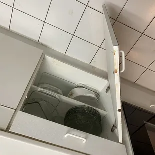 Cabinet under the stove.